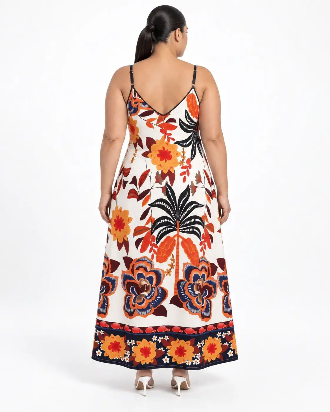 Vestido longo plus size com estampa botânica multicolorida visto de costas, com alças finas e decote em V.