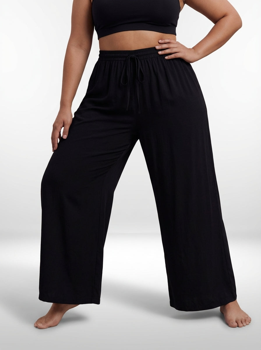 Calça pantalona plus size preta com amarração frontal, caimento leve e visual casual elegante