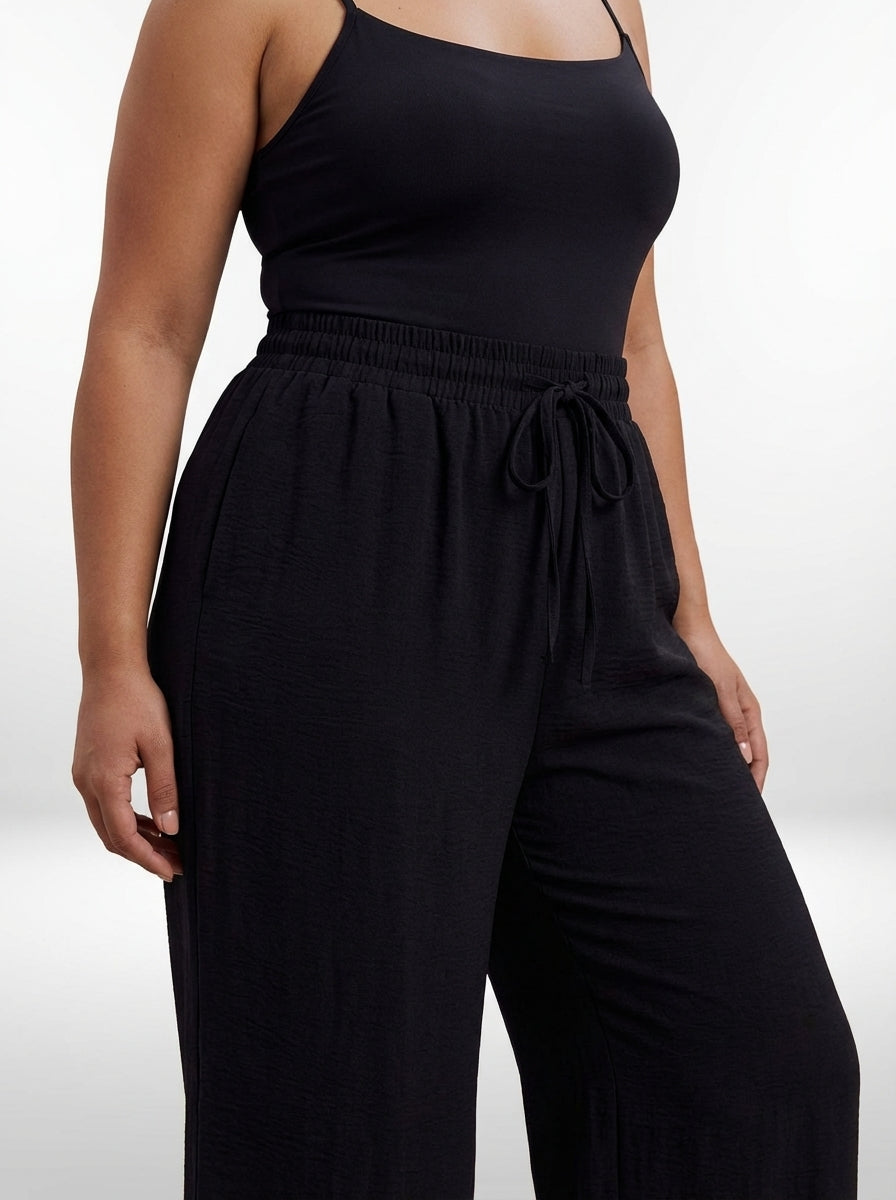 Calça pantalona plus size de cintura alta com comprimento longo e tecido não elástico